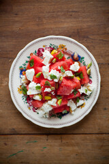 Feta and water melon salad on rustic table