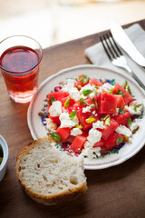 Feta and water melon salad on rustic table