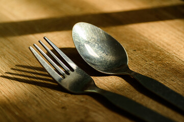 spoon and fork on wooden background