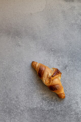 Freshly baked croissants on beautiful textured concrete background