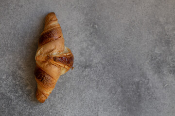 Freshly baked croissants on beautiful textured concrete background
