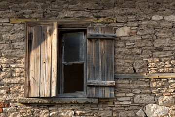 Fototapeta na wymiar Old house and broken window with wooden lid