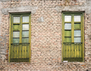 green old windows on brick wall