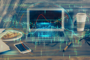 Double exposure of forex graph and work space with computer. Concept of international online...