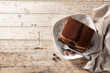 Traditional tiramisu cake on wooden table. Top view. Copy space