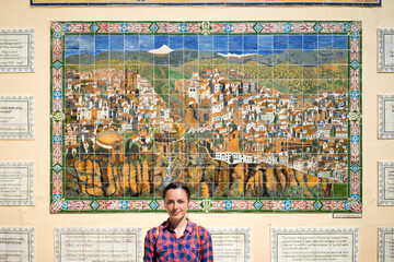 Woman in front mosaic map of Ronda, Andalusia, Spain