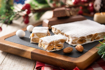 Fototapeta na wymiar Assortment of Christmas nougat and marzipan on wooden table 