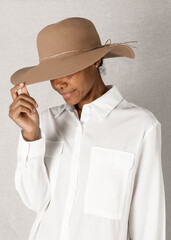 Black woman wearing a wide brim beach hat