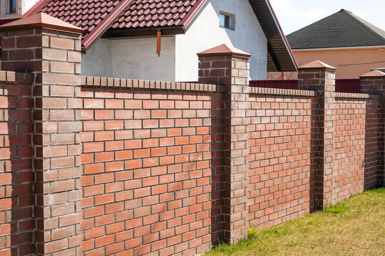Brick fence. Protective brick wall. Outdoor