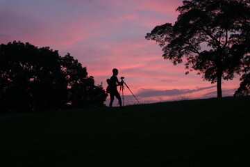 photographer taking picture with tripod