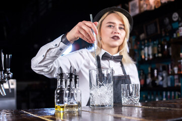 Girl bartender makes a cocktail on the bar © Mr. Prof