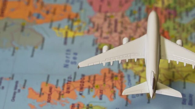Toy of white plane flying over the Europe map.