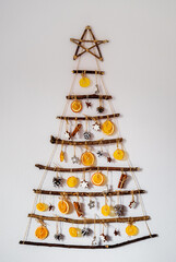 Handmade craft Christmas tree from sticks and natural materials. Sustainable Christmas, zero waste,...