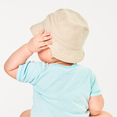 Baby wearing beige bucket hat