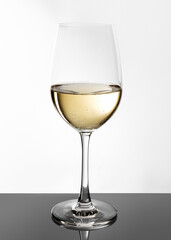 Glass of white wine on white background