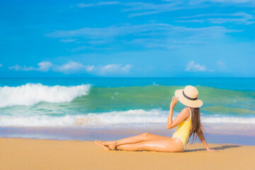 Fototapeta na wymiar Portrait beautiful young asian woman relax smile leisure around outdoor sea beach ocean