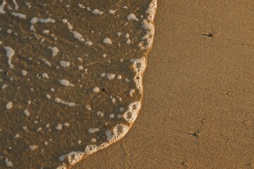 Clear sea water, wave and sand beach. Text space.