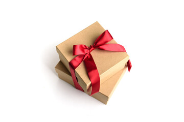 Two craft gift boxes with red ribbon bow isolated on white background.
