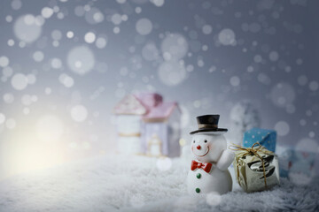 Happy snowman with xmas presents on sunny winter day.Merry Christmas and happy new year concept background.