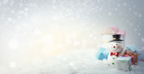 Happy snow man with xmas presents on sunny winter day.Merry Christmas and happy new year concept...