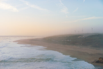 eolian mills on the background foggy day on the ocean