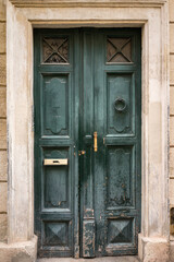 green  door with bronze details