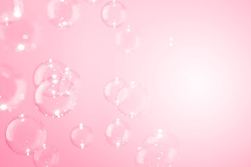 Beautiful shiny transparent soap bubbles float on a pink texture background. Sweet valentines card. Natural freshness summer holiday pink background.