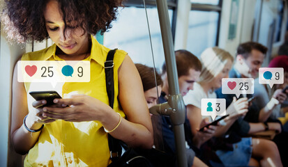 People using social media on their smartphones in the subway