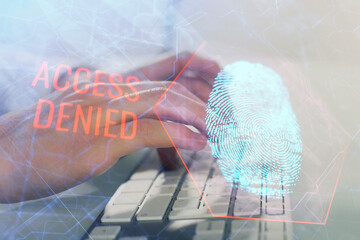 Fingerprint hologram with businessman working on computer on background. Security concept. Double...
