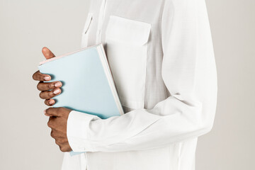 Black woman holding books in her hand