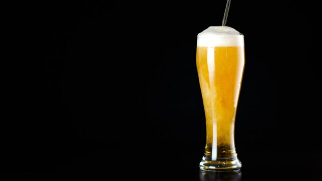 Cinemagraph, Beer Is Poured Into A Glass On Black Background