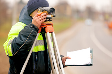 Professional engineer surveyor making measure with tacheometer theodolite before startup...