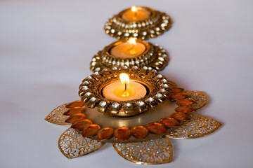 Decorative candles in golden holders, warm festival vibe. Peaceful zen lights.