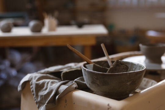 Potter tools lying on a working table in a pottery studio - Powered by Adobe