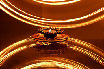candle in decorative holder for a warm festive look with a creative long exposure golden-yellow background.