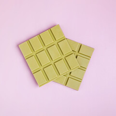 Square bars of milk chocolate of green color