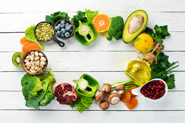 Food background: fruits, vegetables and berries on a white wooden background. Top view. Rustic style.