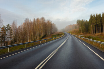 Fototapeta premium Highway without cars. fog in the distance. Autumn day. in Finland .