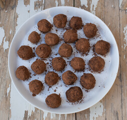 A plate of homemade chocolate truffles coated in cocoa powder