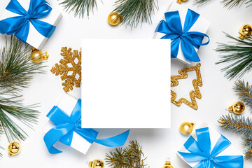 Gift ribbon box. White gift box with blue ribbon, New Year balls and Christmas tree in xmas...