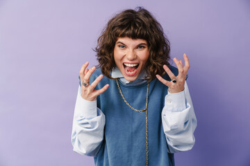 Furious caucasian girl posing and screaming at camera