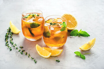 Iced tea with ice, mint and lemon. Refreshment cold summer drink.