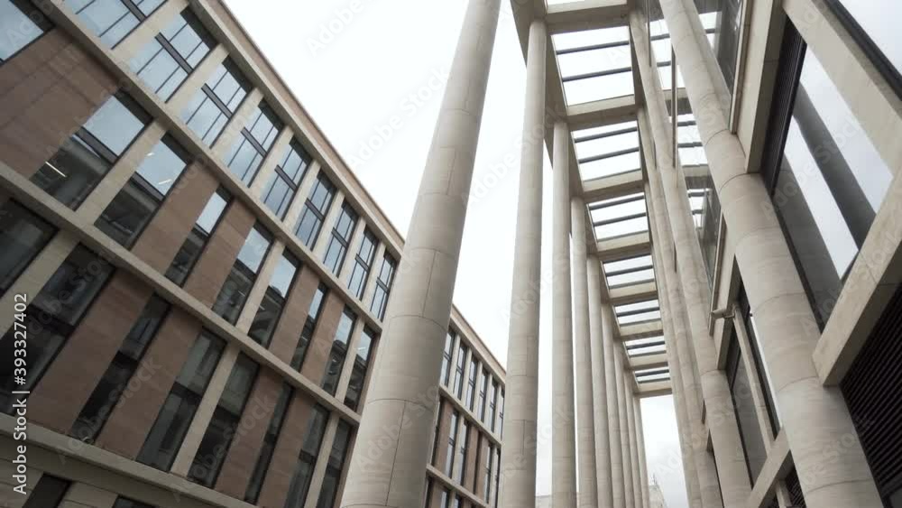 Poster facade of a building with marble columns. action. bottom view of a modern architectural complex, new