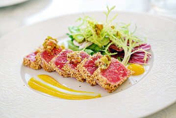 sliced tuna steak with sesame and vegetables