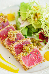 sliced tuna steak with sesame and vegetables