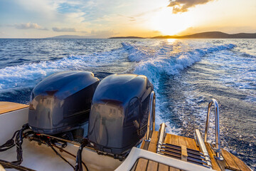 Yacht engine at sea during sunset, boat engines driving over the water