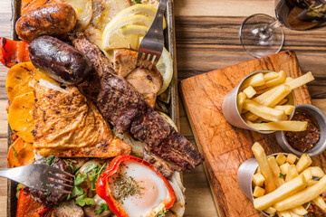 ready-to-eat barbecue of meat and chicken with fries