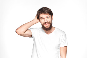 Obraz premium Bearded man in white t-shirt gesture with hands emotions light background