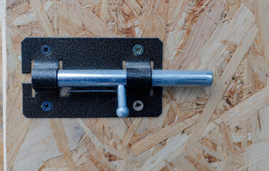 metal latch on a wooden door close up