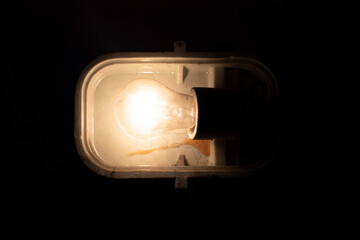 Loft industrial stylized lamp / reflector/ headlight / spotlight hanging on the dirty wall in the basement / magazine